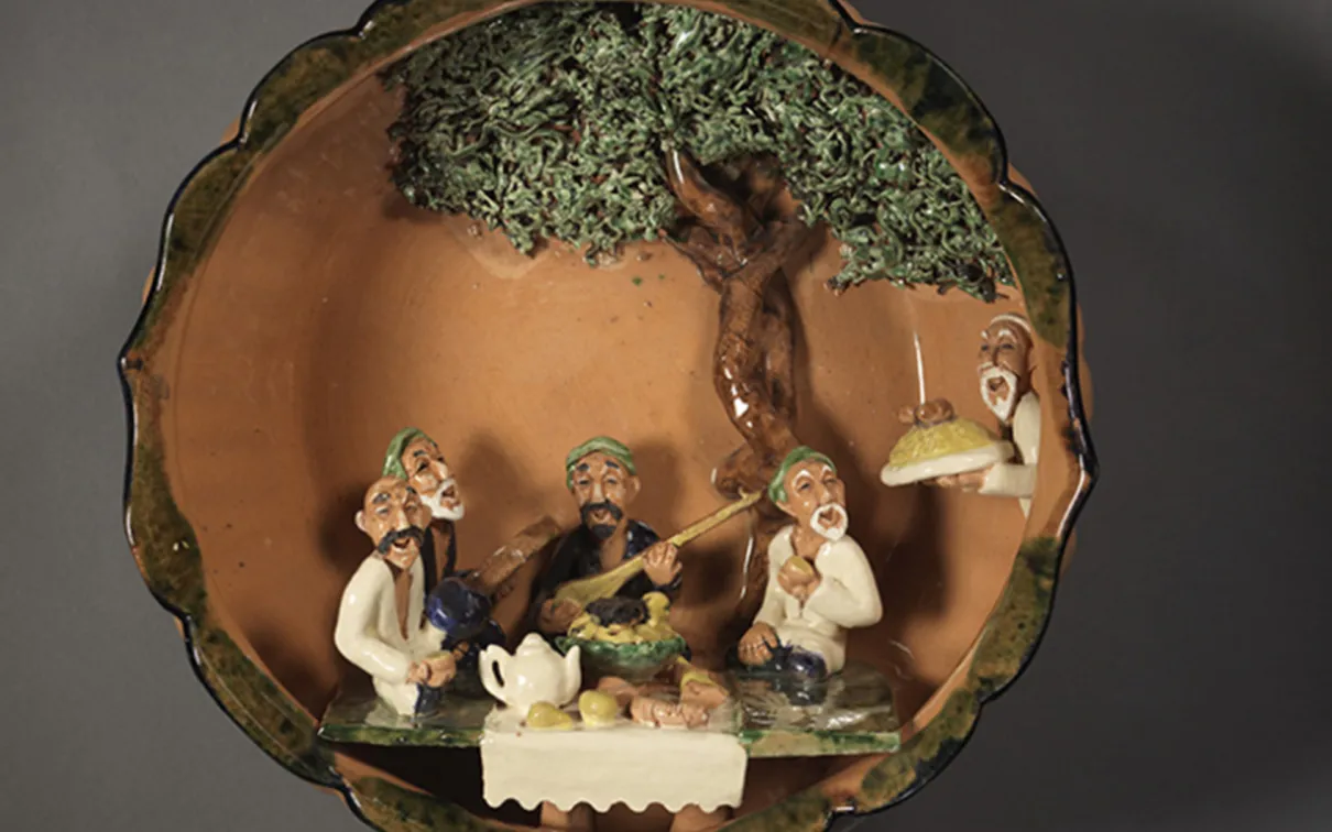 Earthenware bowl with moulded figures.