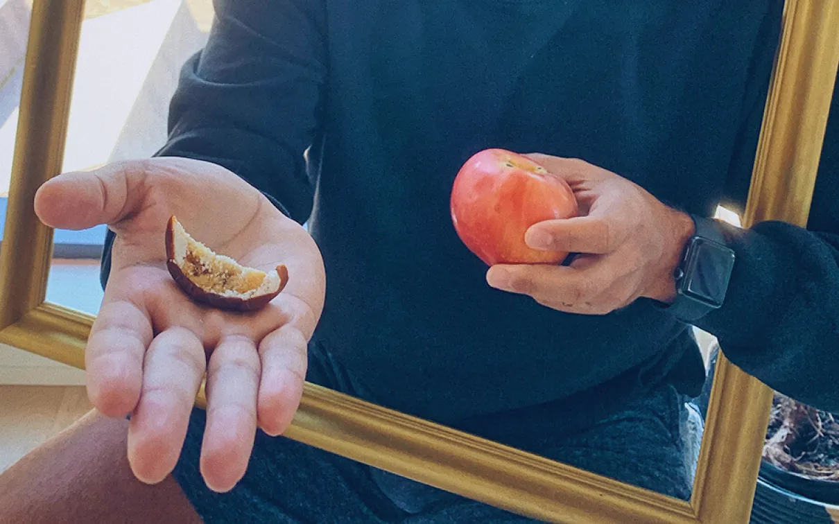 Kiron Mukherjee holding an apple.
