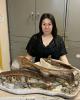 Shino Sugimoto with a dinosaur fossil cast.