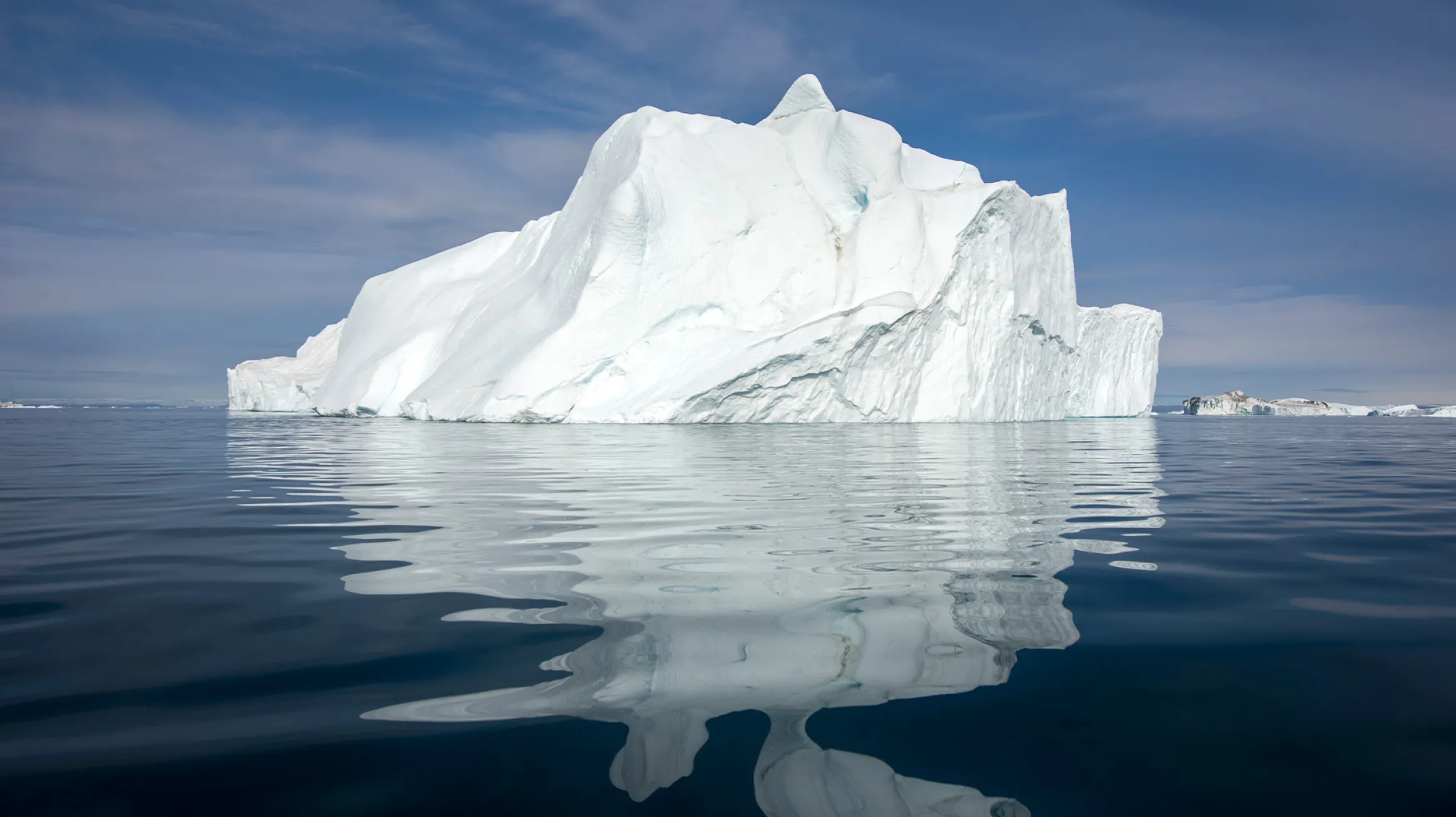 An iceberg in the water off the coast of Greenland.
